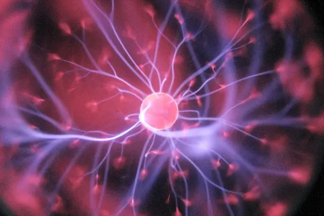 Leuchtende Plasmakugel mit rosa Kern und blau-violetten Lichtbögen als Bezug zum Kurssprung des Energieunternehmens X-Energy