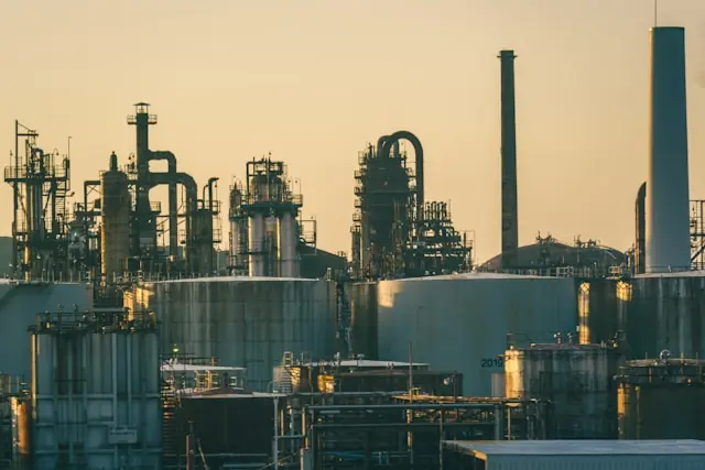 Industrieanlage mit Raffinerietürmen und Lagertanks im Abendlicht im Kontext des NYSE-Börsengangs von WaterBridge