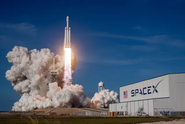 Raketenstart von SpaceX vor einem Firmengebäude des Raumfahrtunternehmens. SpaceX bereitet den Börsengang vor, der mit einer Bewertung von bis zu 1,8 Billionen US-Dollar als größter IPO der Geschichte gelten könnte.